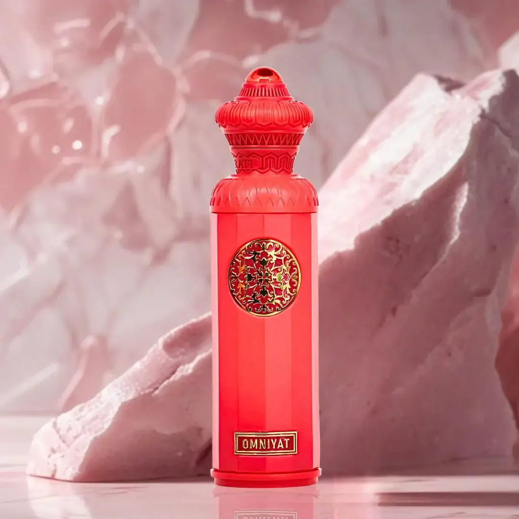 OMNIYAT by Surrati Heritage Collection EDP 140ml in vibrant red bottle against a soft pink background.