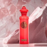 OMNIYAT by Surrati Heritage Collection EDP 140ml in vibrant red bottle against a soft pink background.